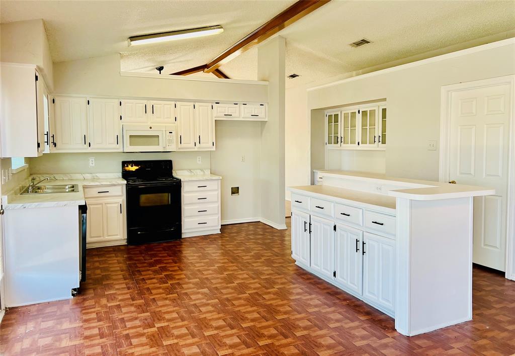 a kitchen with stainless steel appliances granite countertop a sink and cabinets