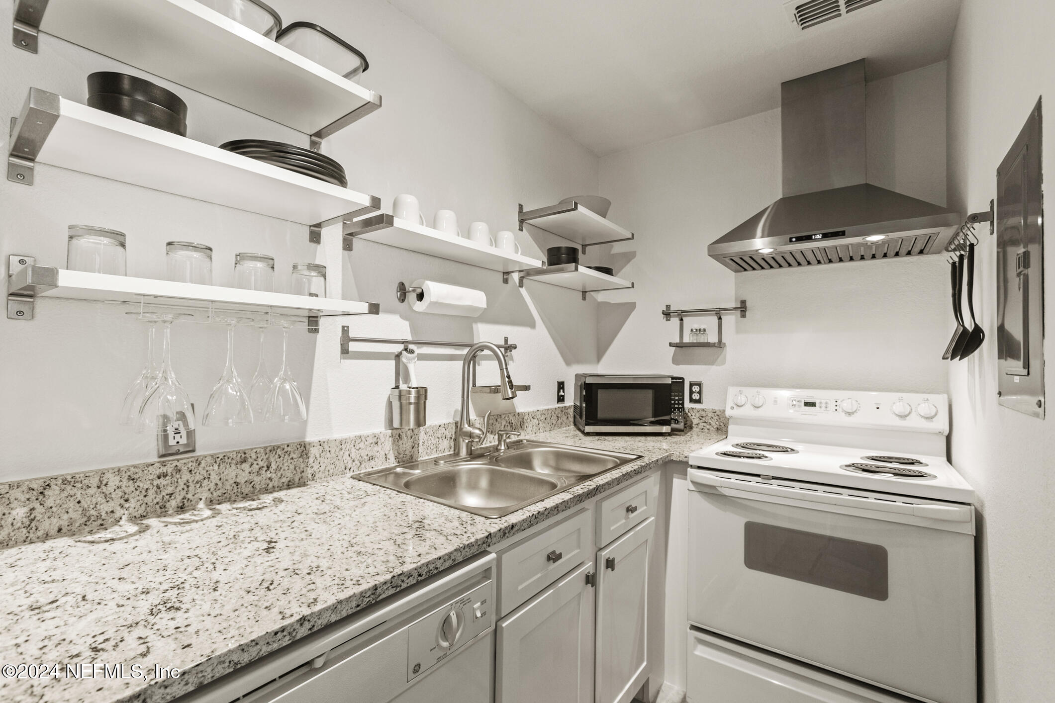 a kitchen with stainless steel appliances granite countertop a sink and stove top oven