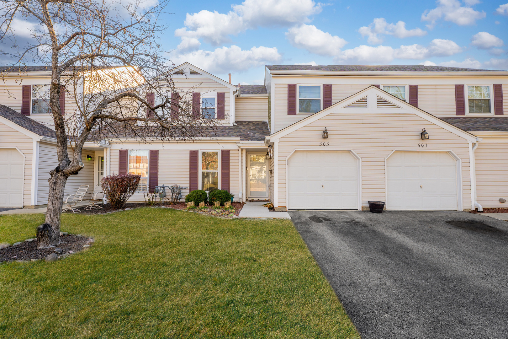 a front view of a house with a yard and garage