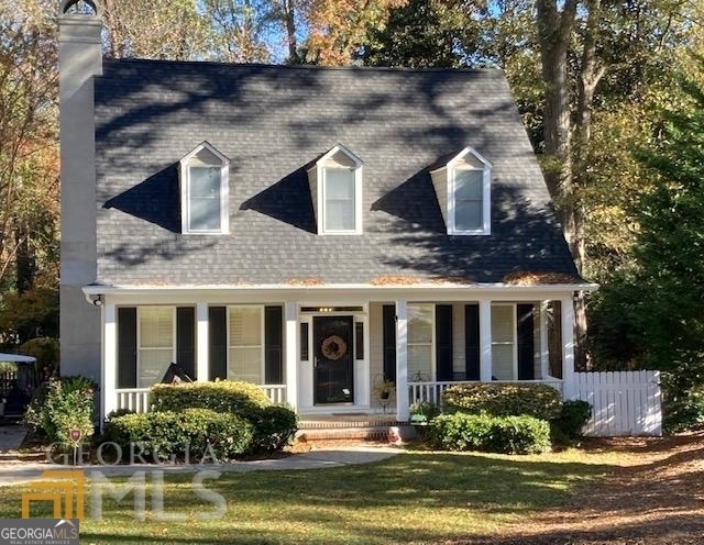 a front view of house with yard swimming pool and outdoor seating