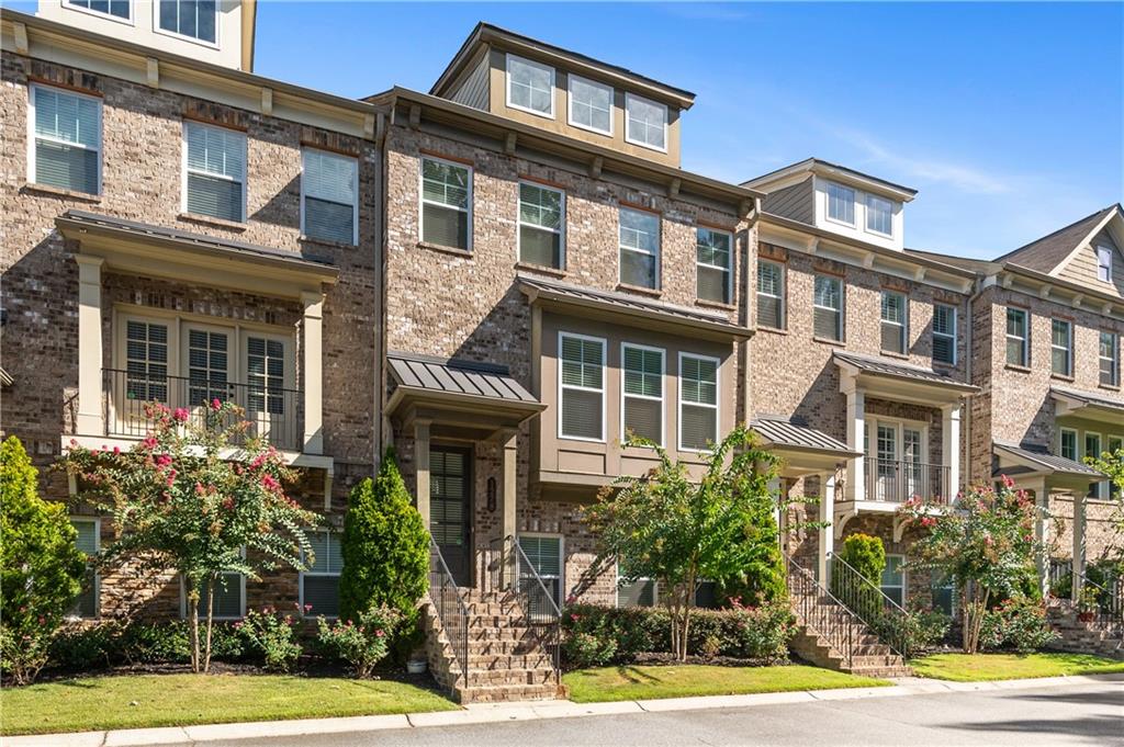 a front view of a residential apartment building with a yard