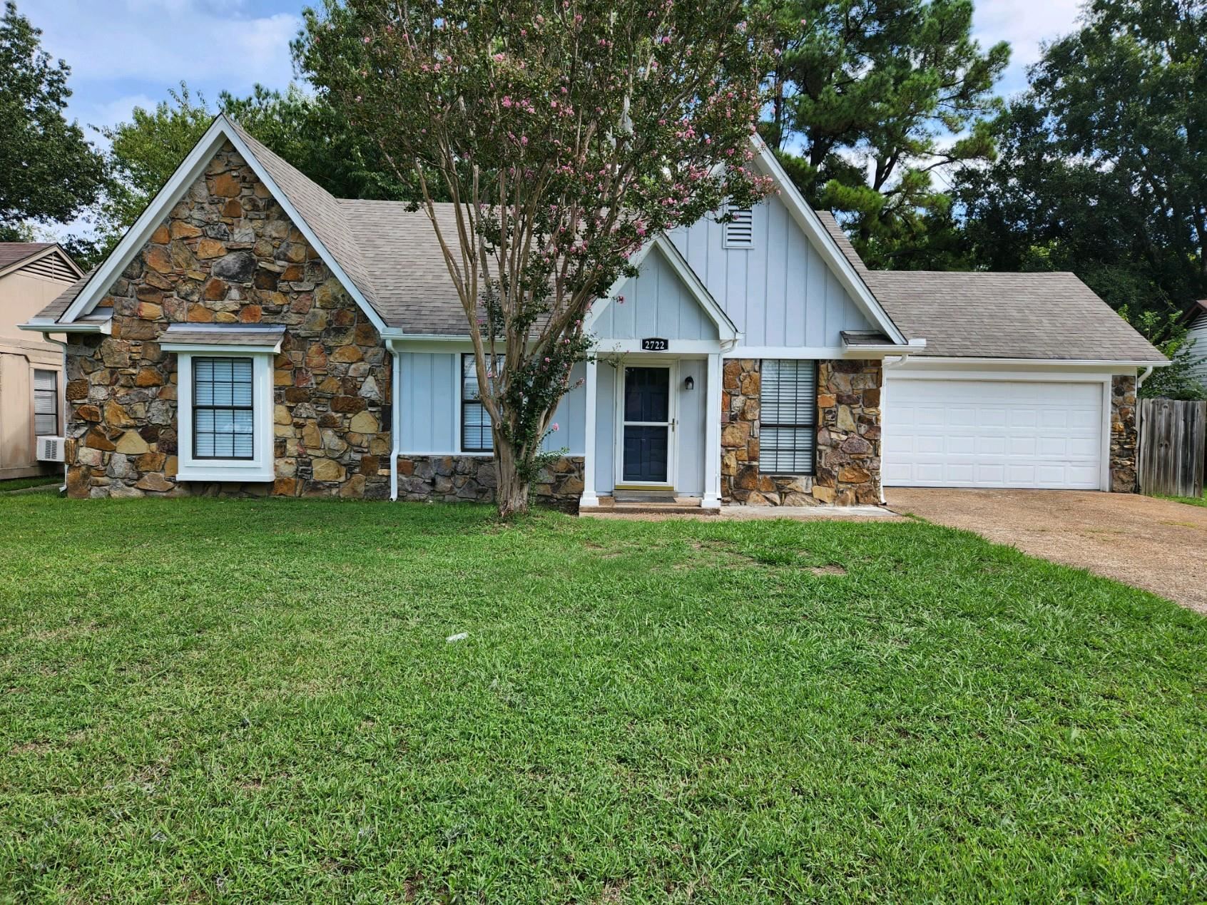 a front view of house with yard and green space