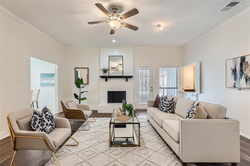 a living room with furniture a fireplace and a chandelier