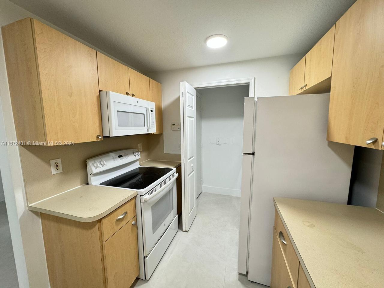 a kitchen with a stove sink and refrigerator