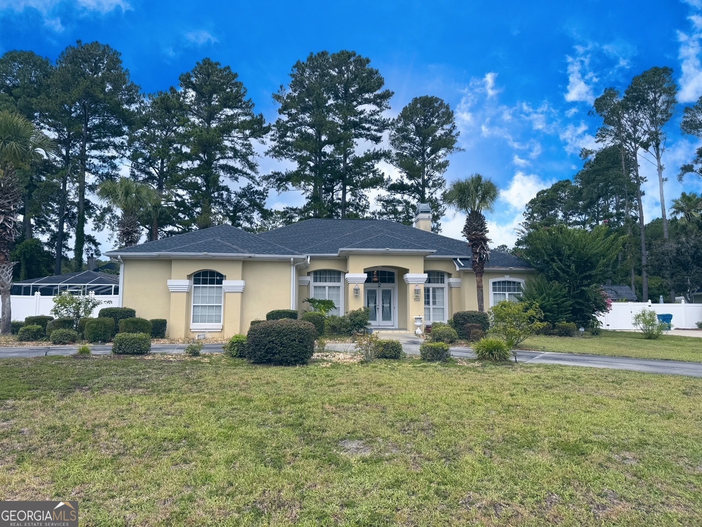 a front view of house with yard and trees