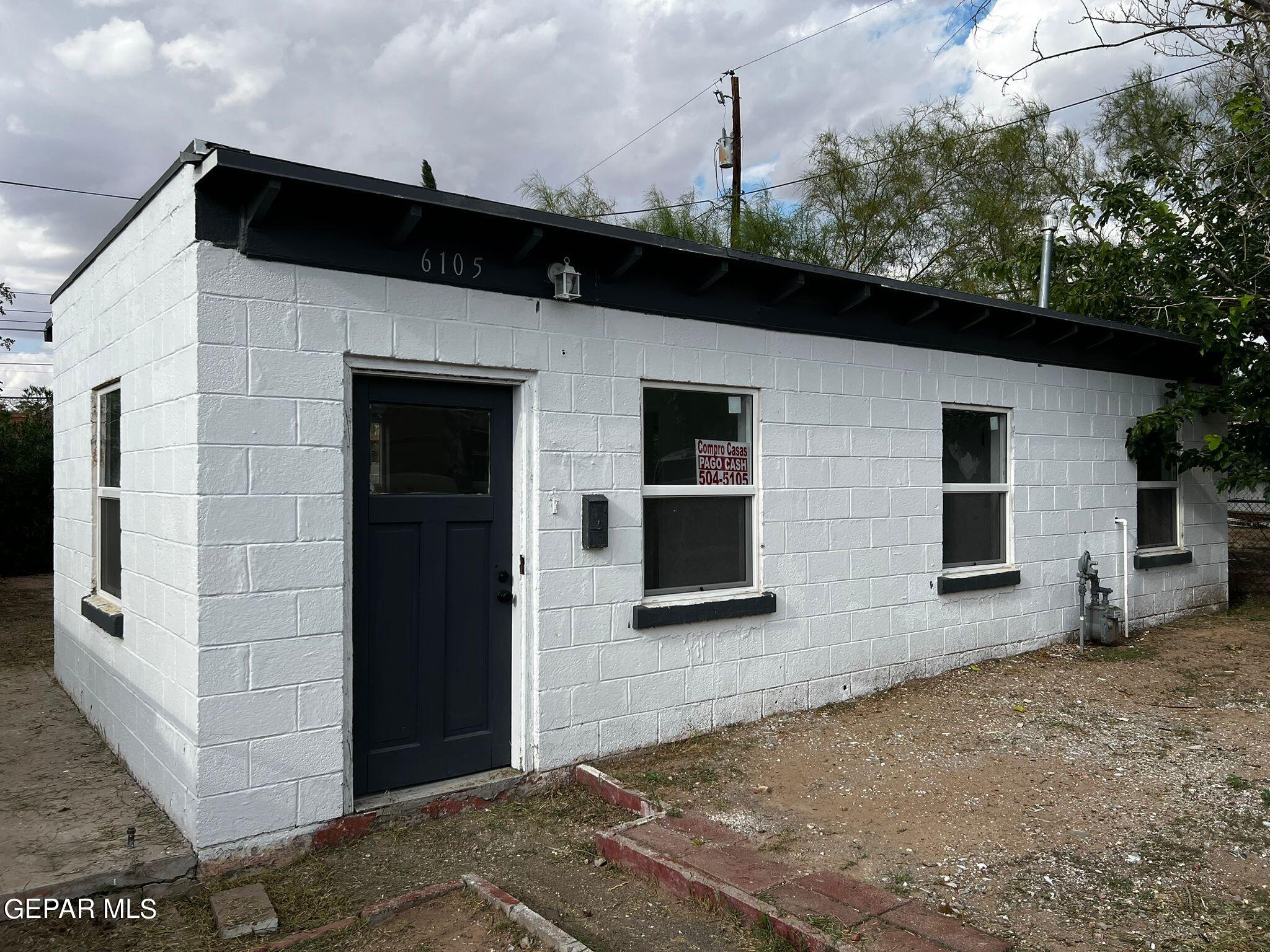 a view of a house with a backyard space