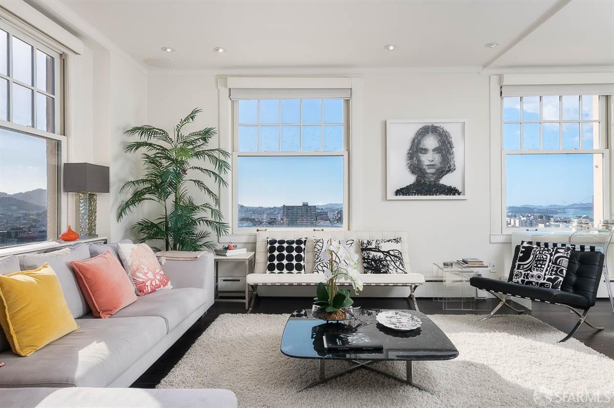 a living room with furniture a rug and a window