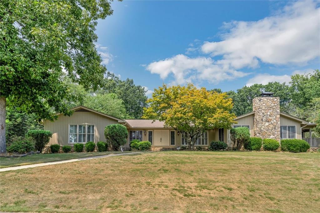 a front view of house with yard and trees