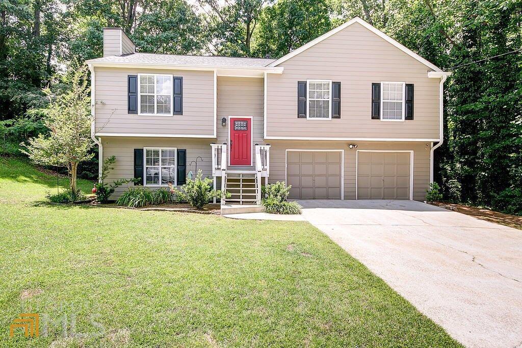 a front view of a house with a yard and garage