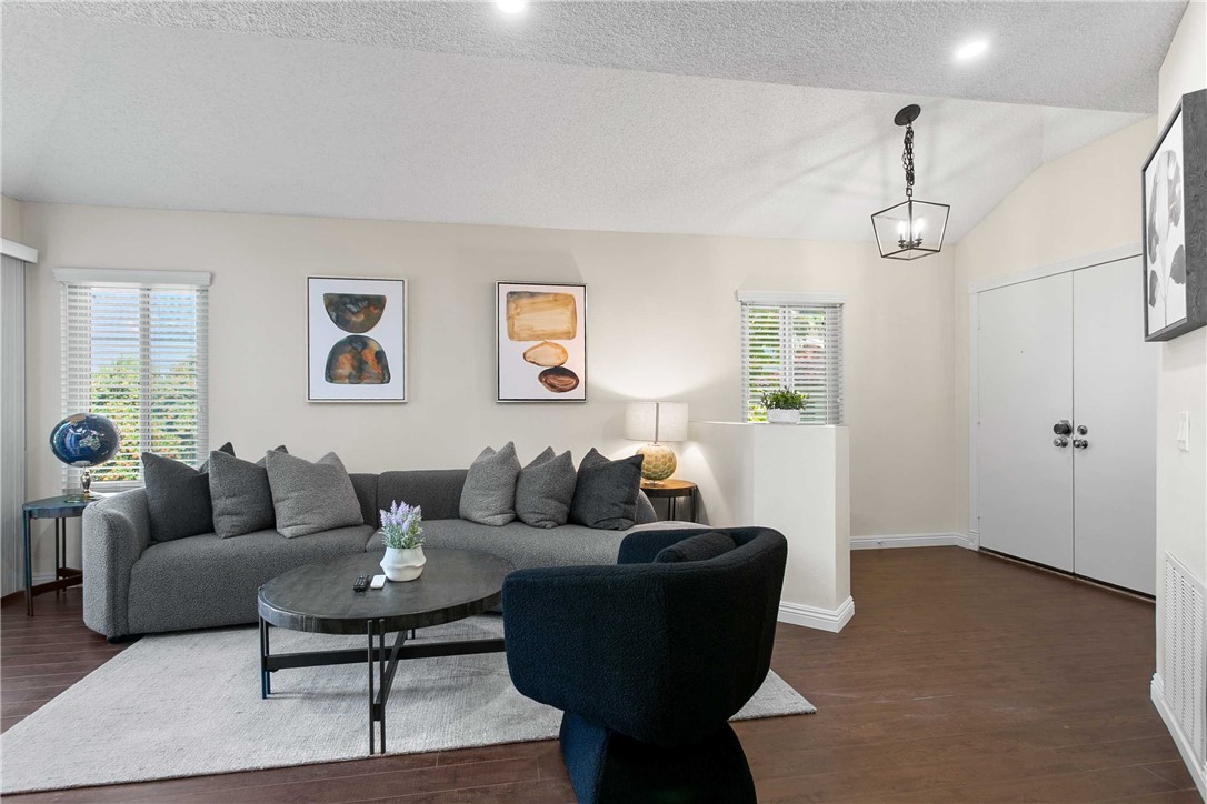 a living room with furniture and wooden floor