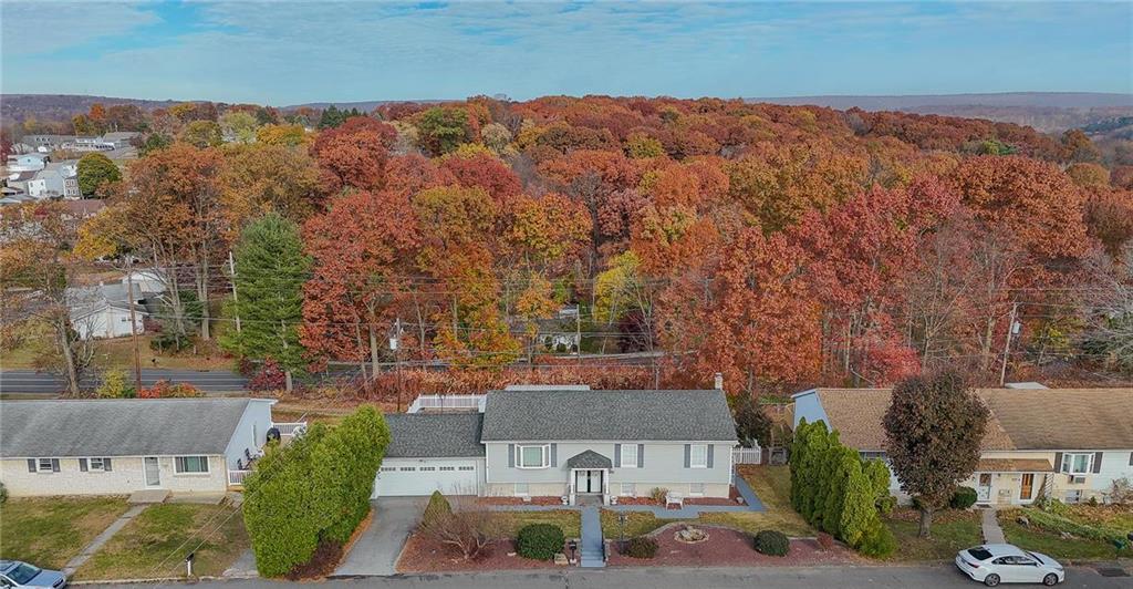 an aerial view of a house with yard and mountain view in back