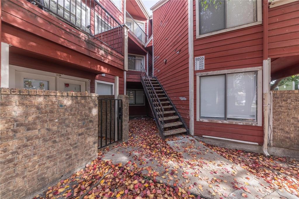 a view of a backyard with stairs and wooden fence