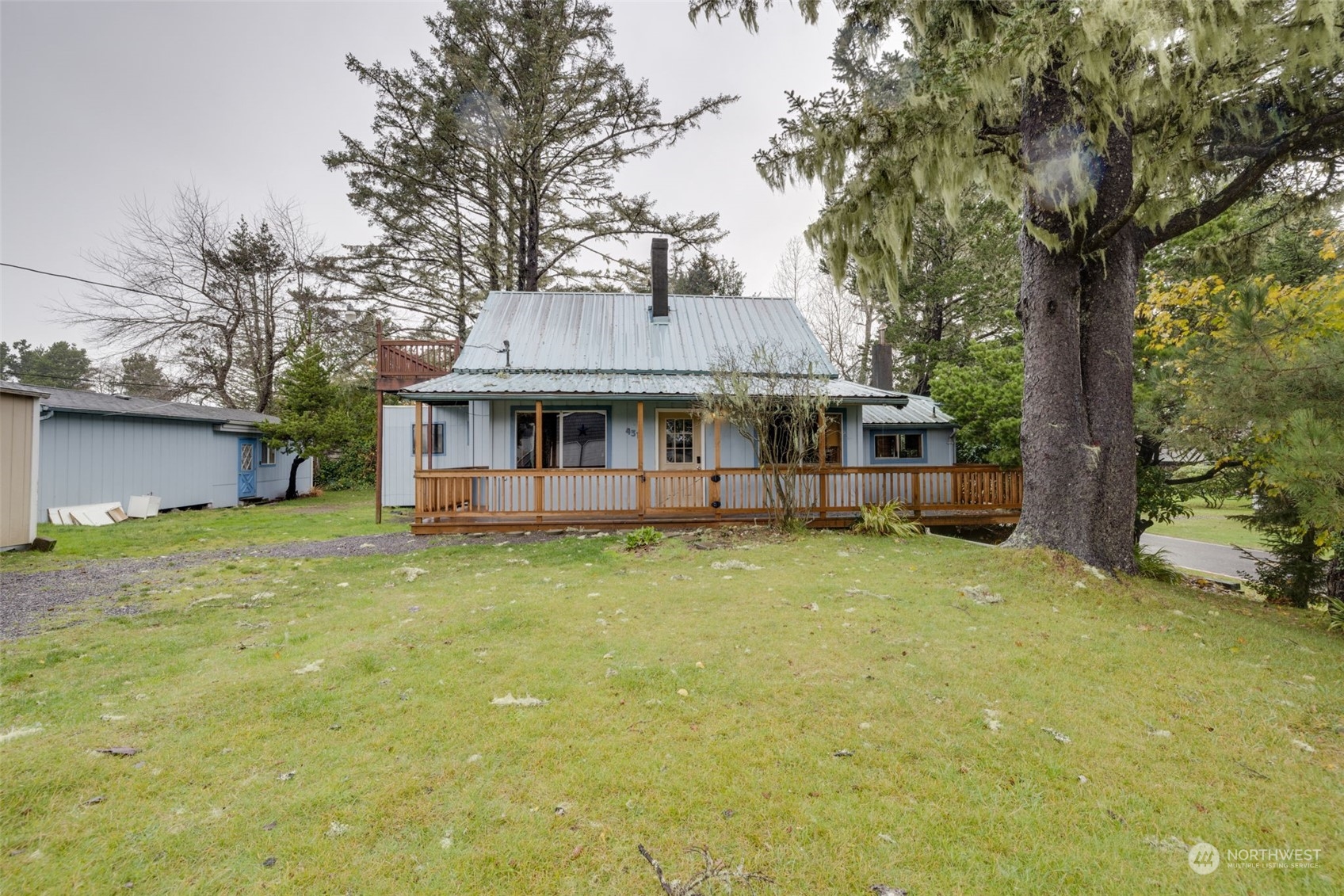 a view of a house with a yard and tree