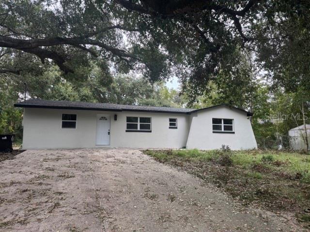 a house that has a tree in front of it