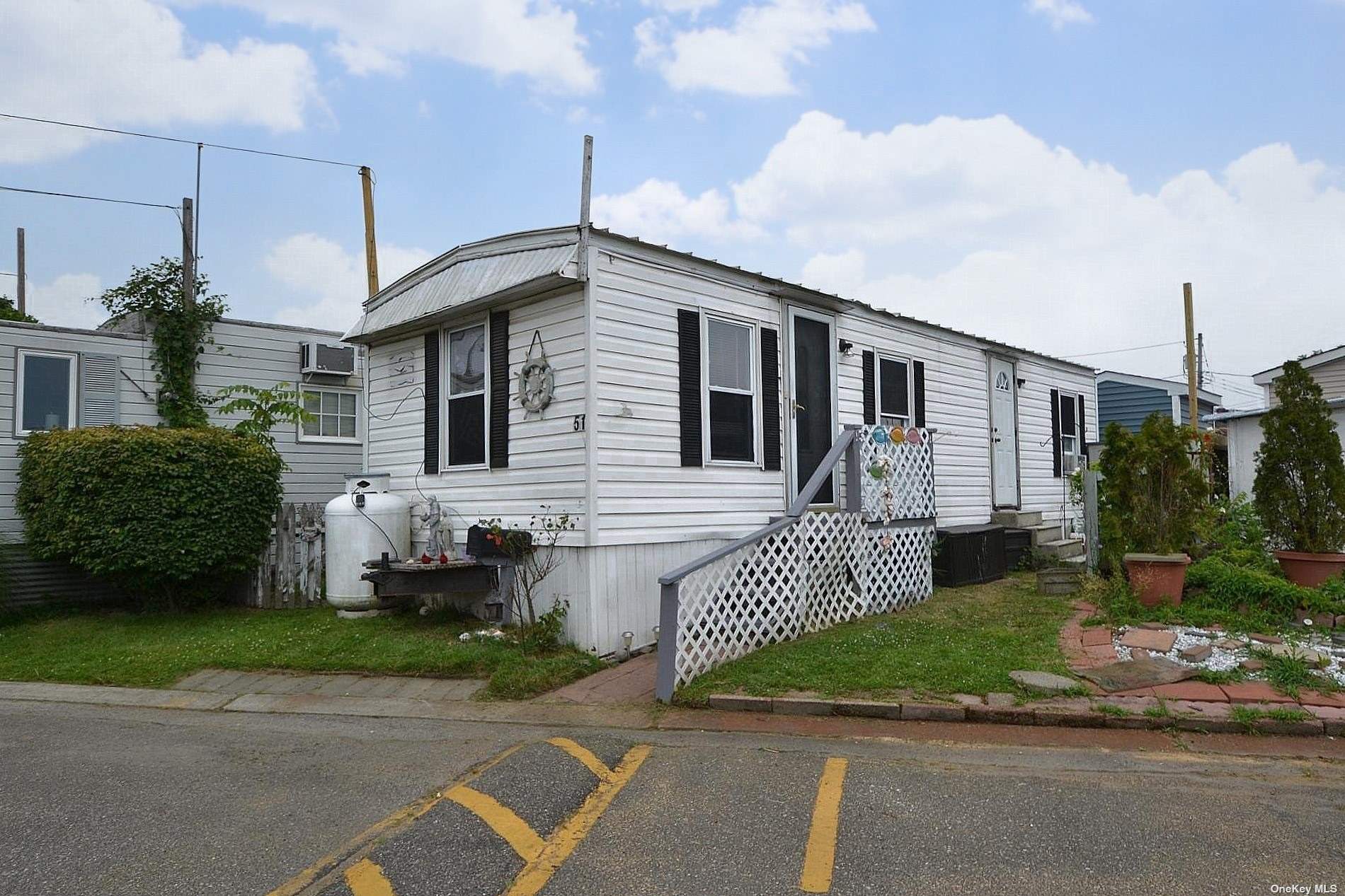 a front view of a house with a garden and plants