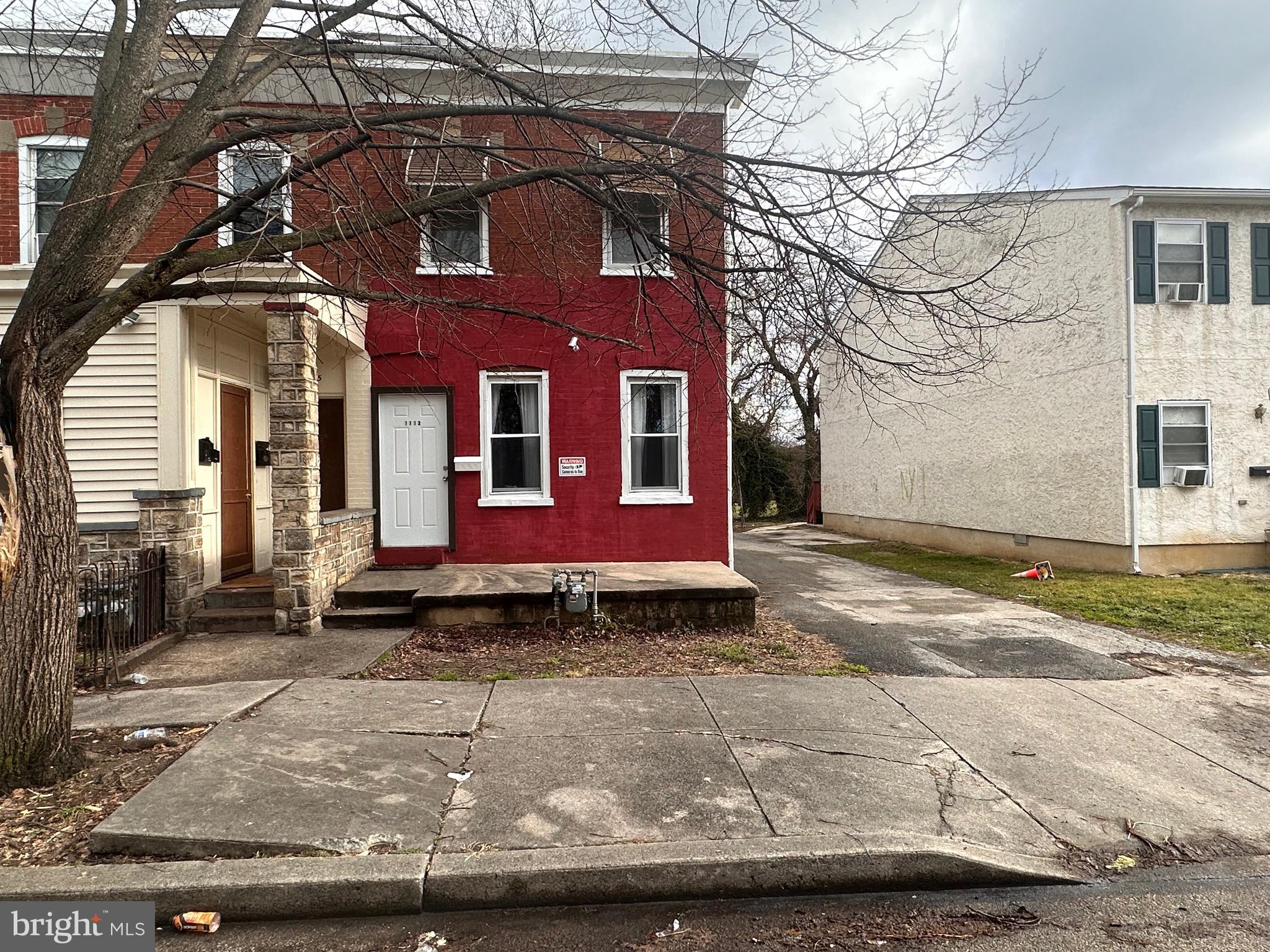 a view of a brick house with a yard