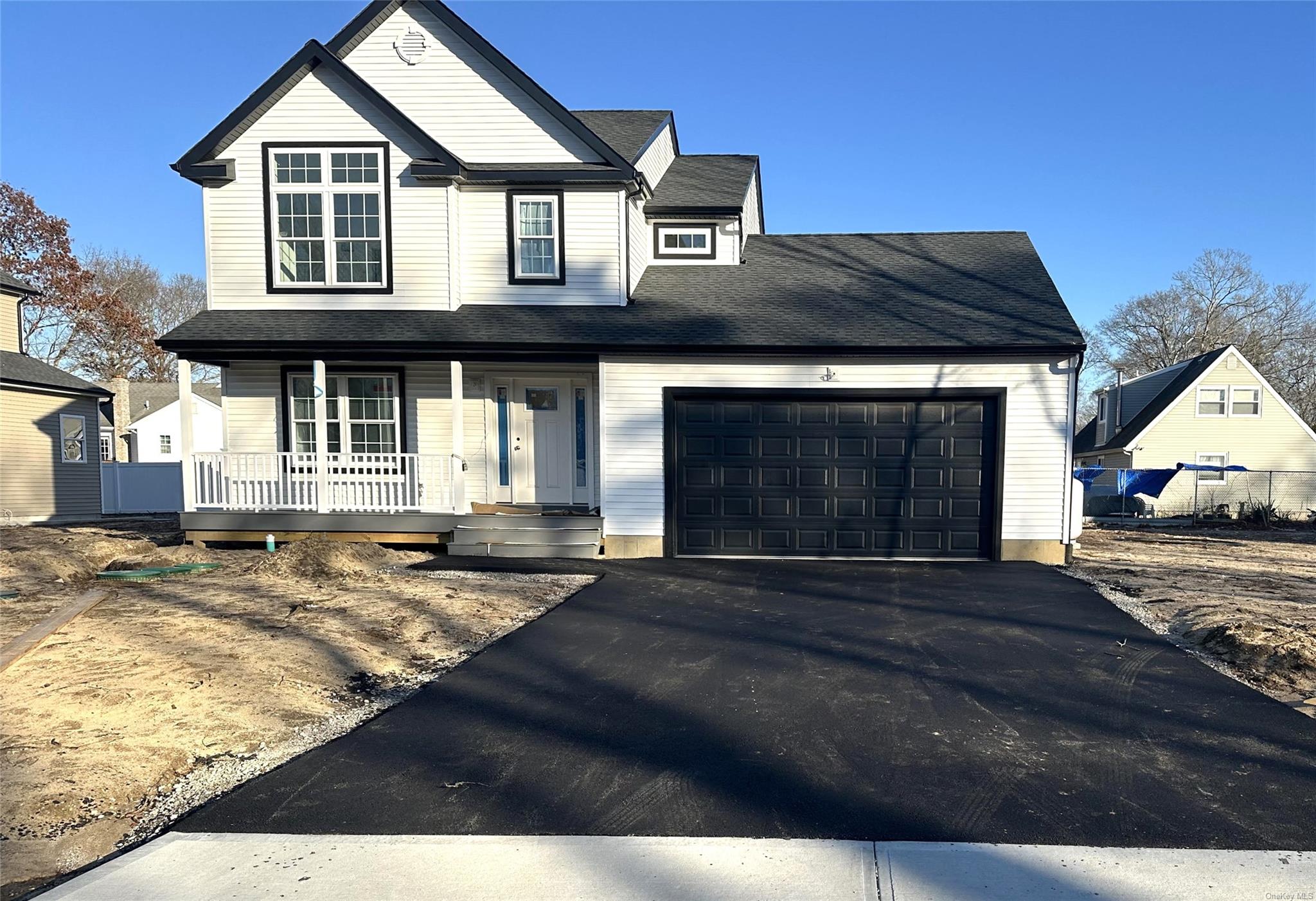 View of front of home featuring a porch and a garage