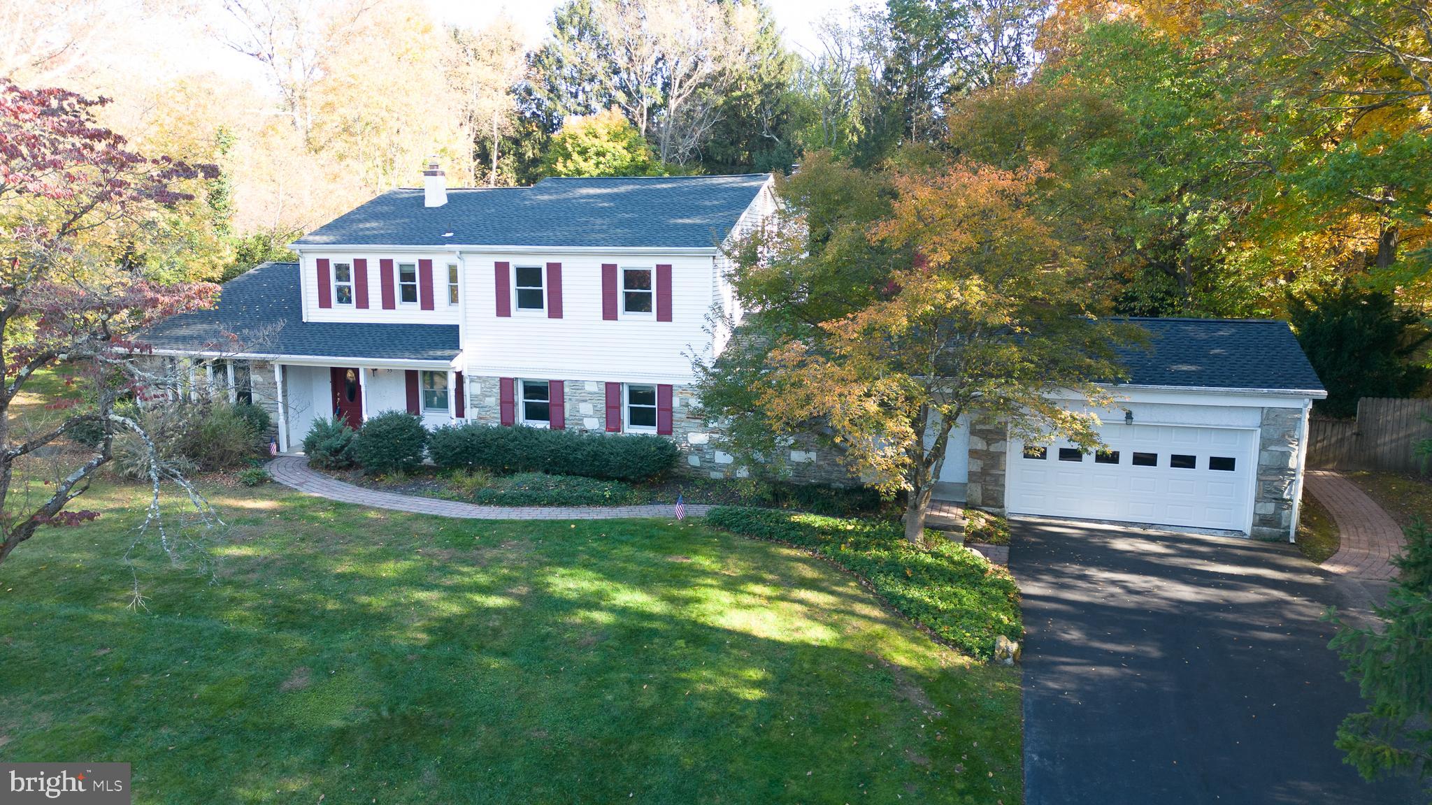 a view of house with yard and green space