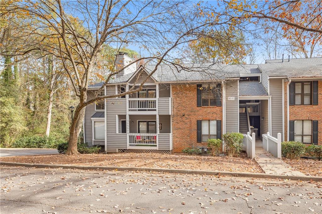 front view of a house with a dry trees