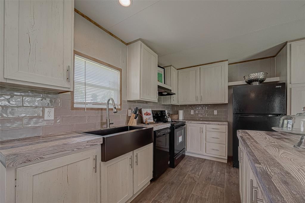 a kitchen with a sink stove and refrigerator