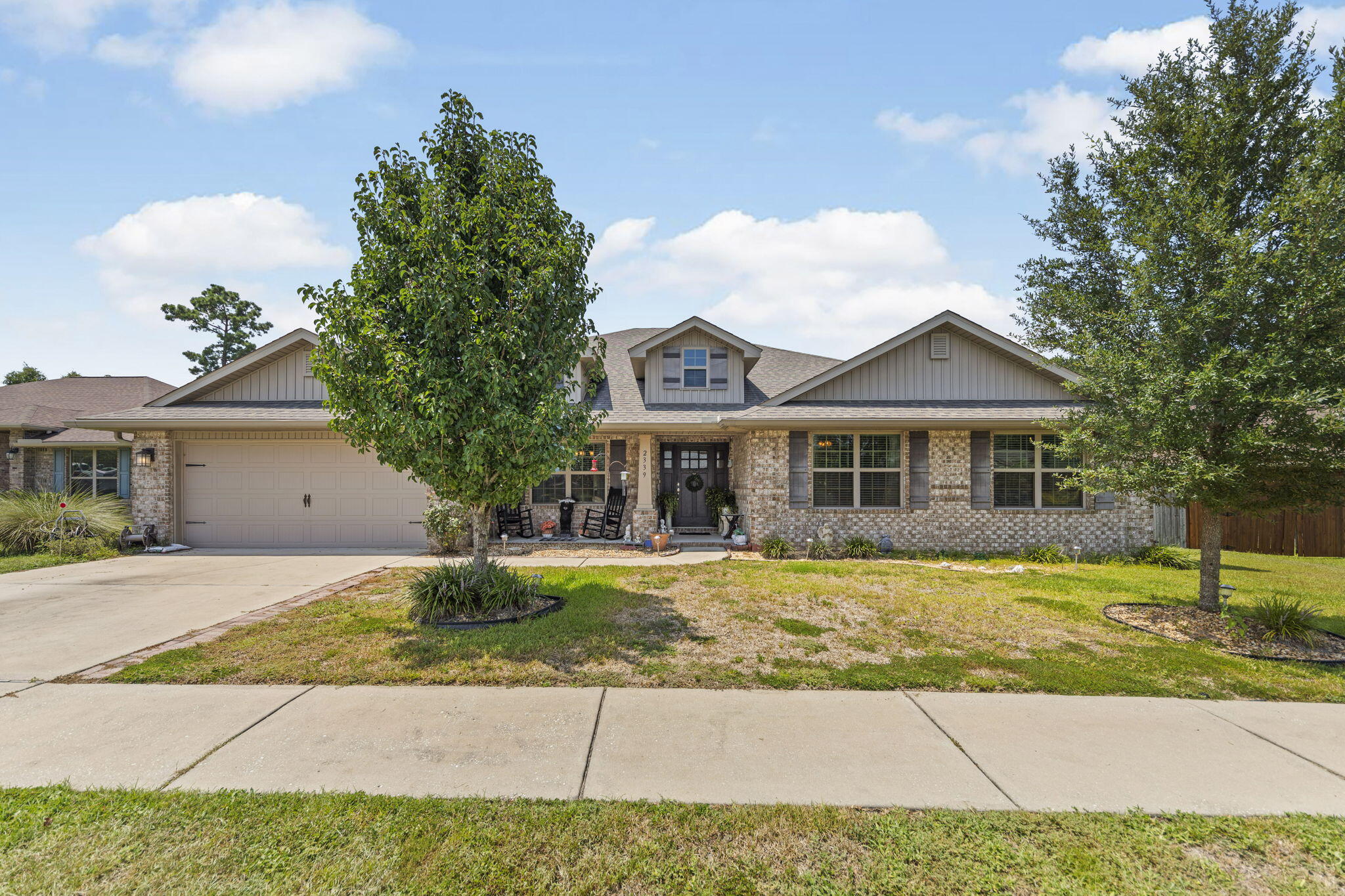 a front view of a house with a garden