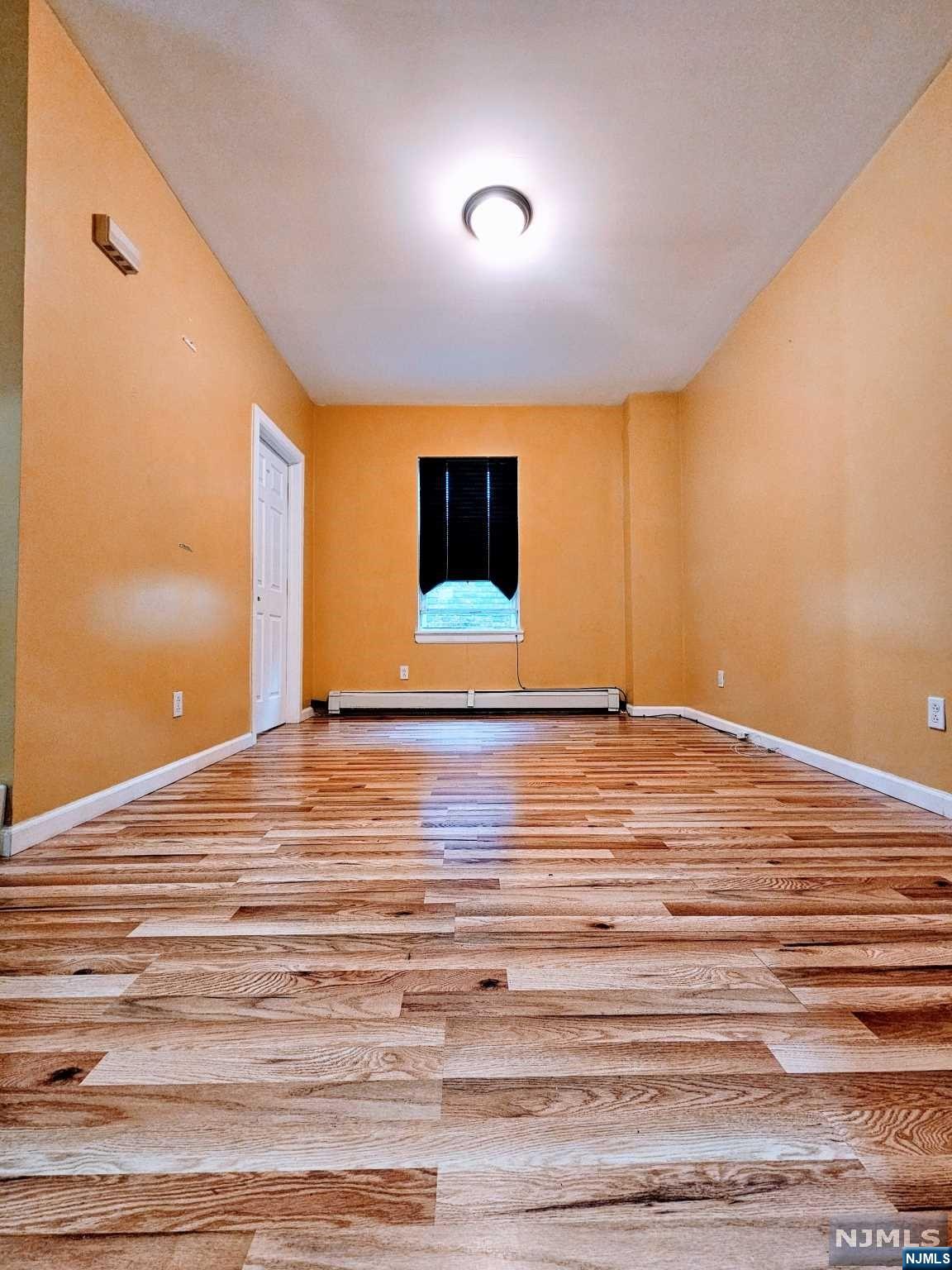 a view of a room with wooden floor and pool table