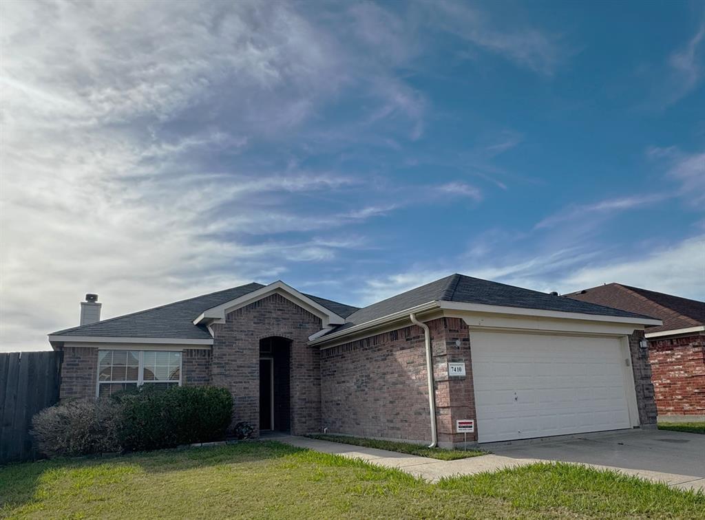 a front view of a house with a garden and yard