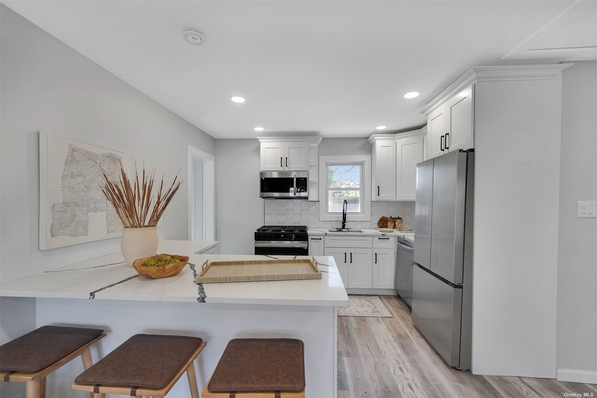 a kitchen with a refrigerator and a stove top oven