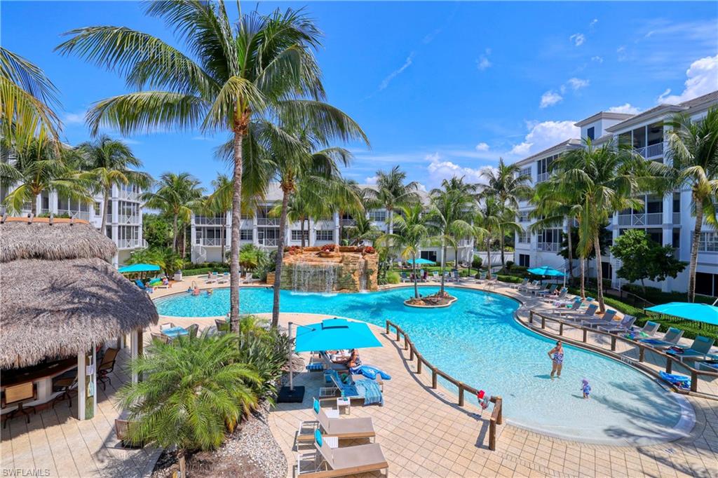 a view of a swimming pool with a patio and a garden