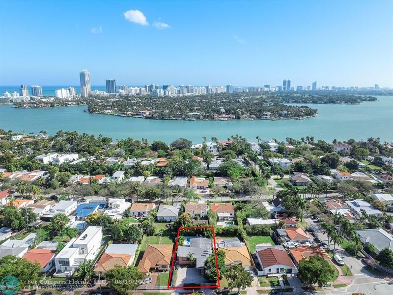 an aerial view of a city with lots of residential buildings lake and ocean view