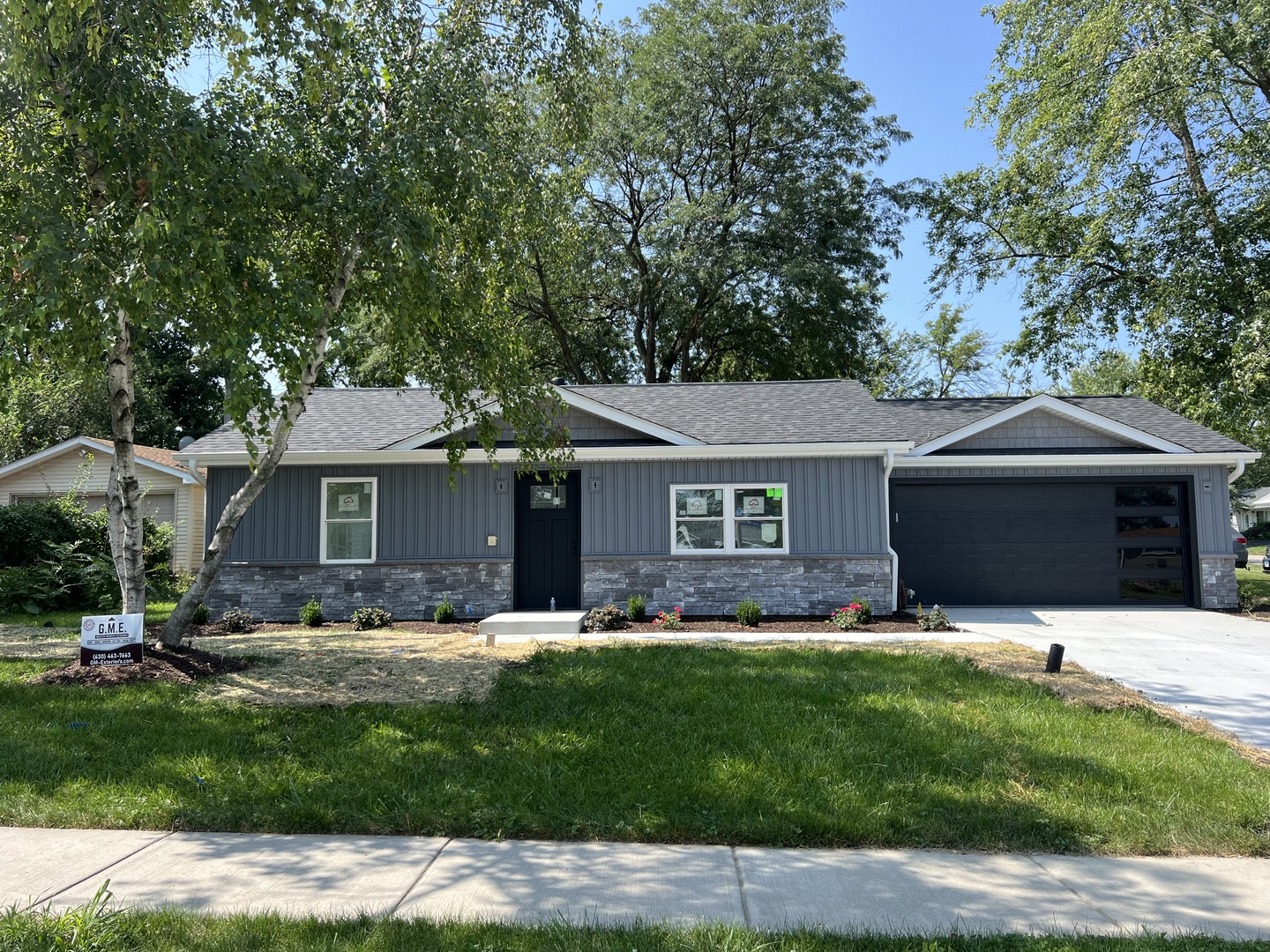 a front view of house with yard and trees