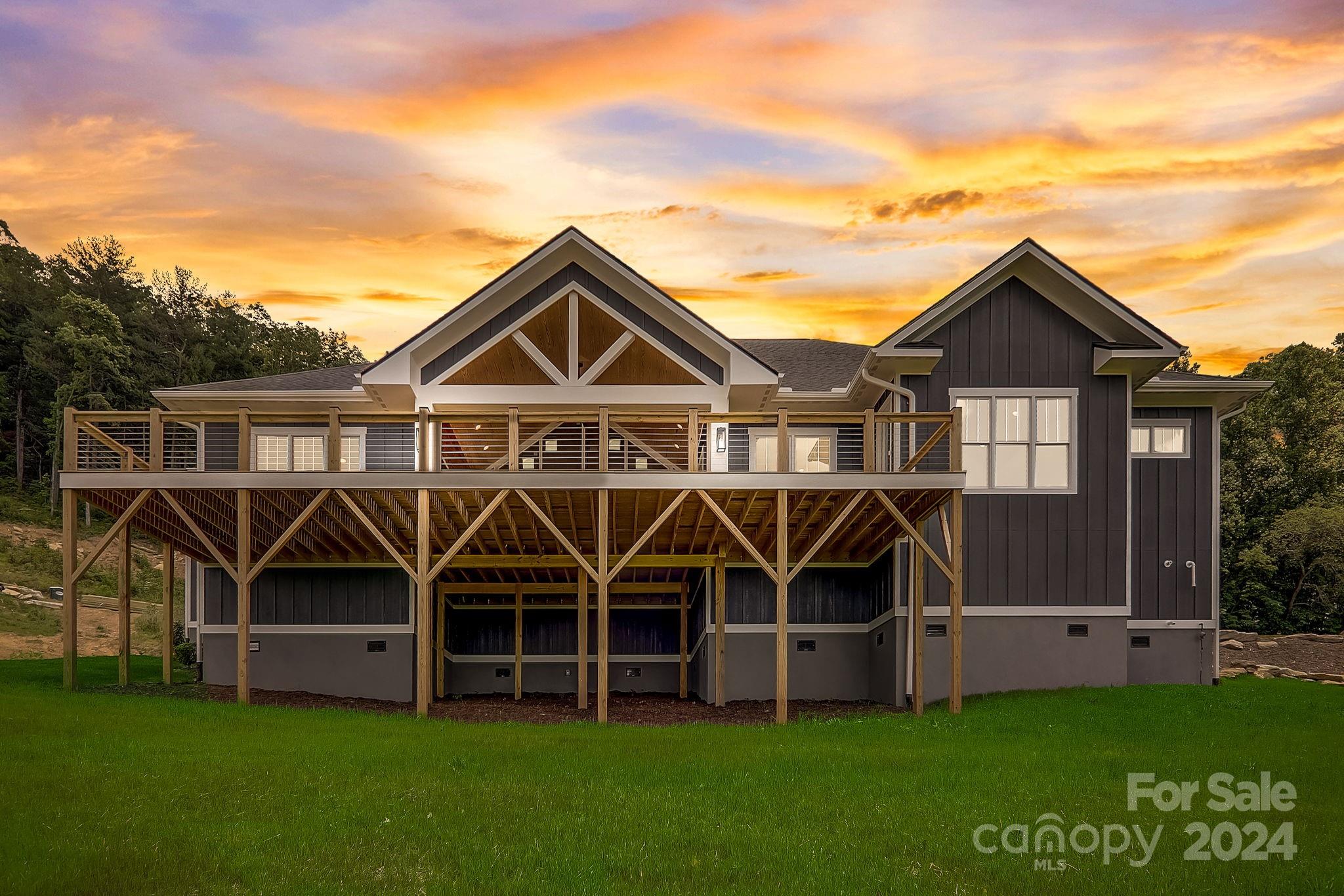 a view of a big house that has wooden fence