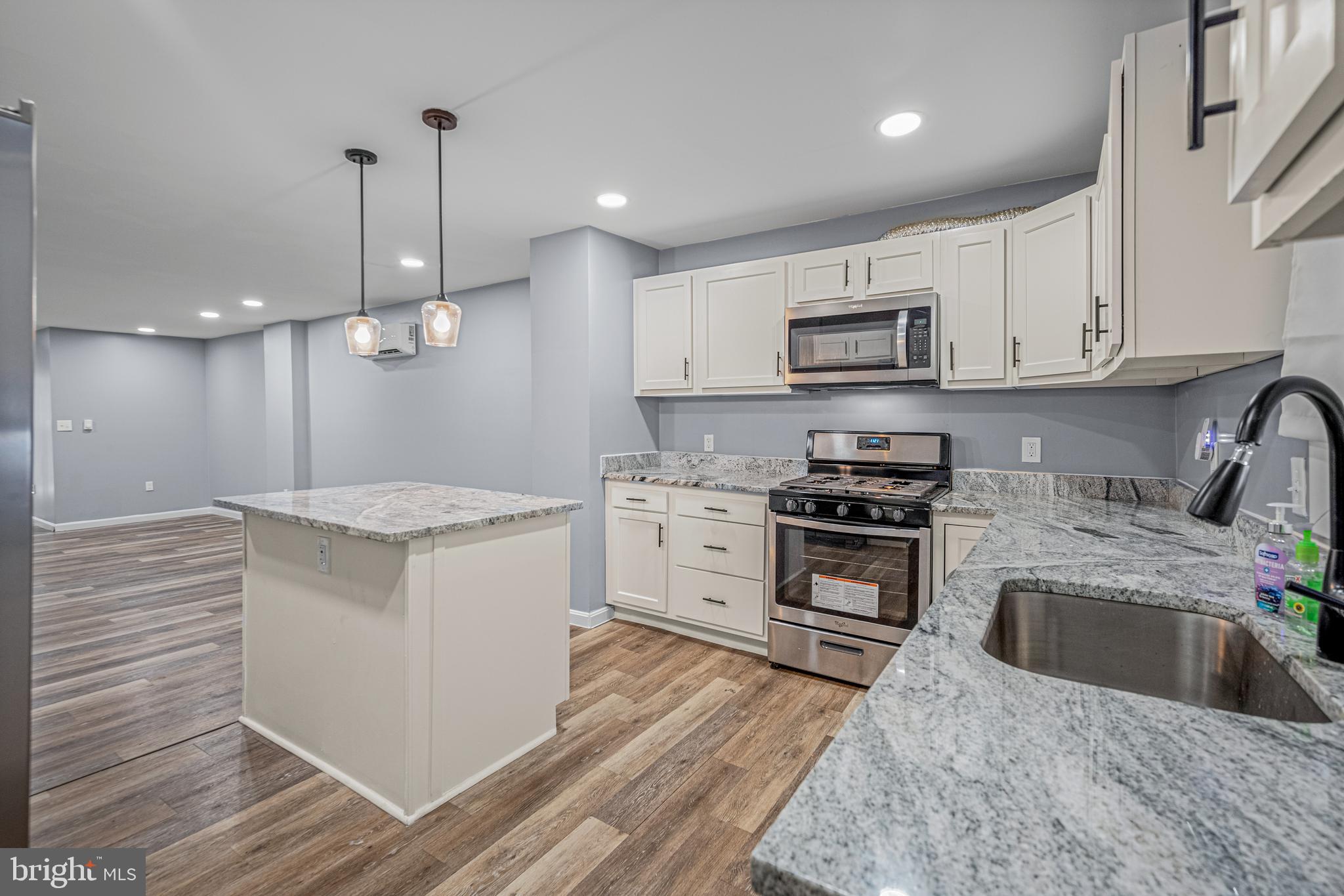 a kitchen with a stove sink and a refrigerator