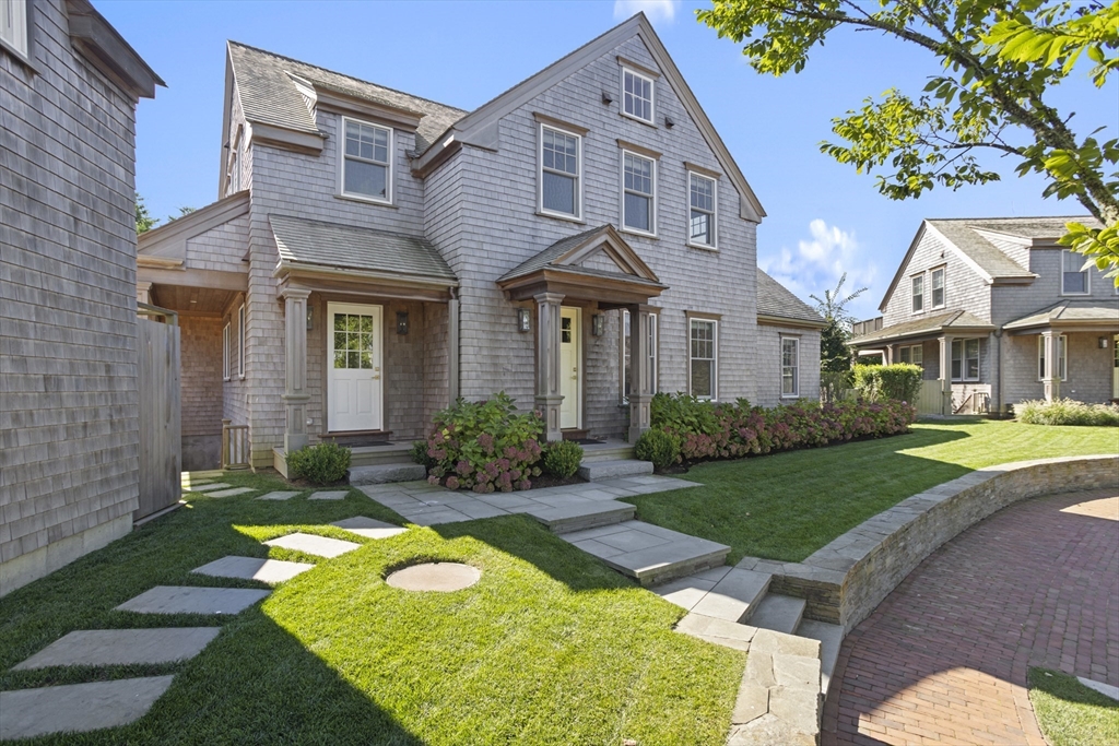 a front view of a house with garden