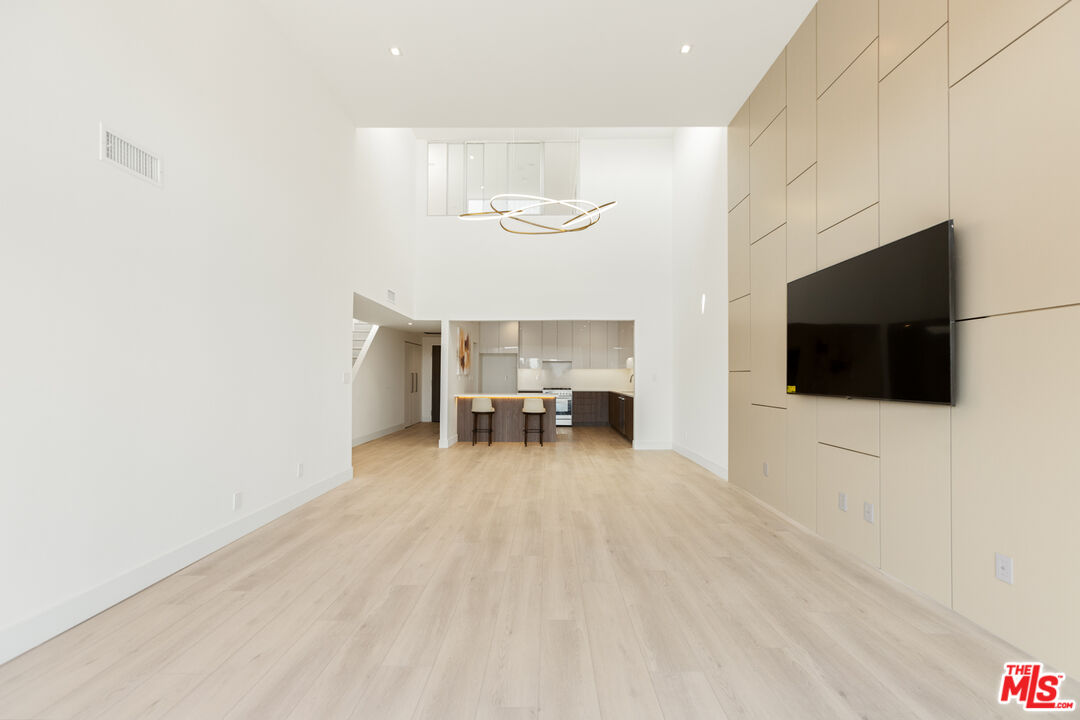 a view of a livingroom with furniture and a flat screen tv