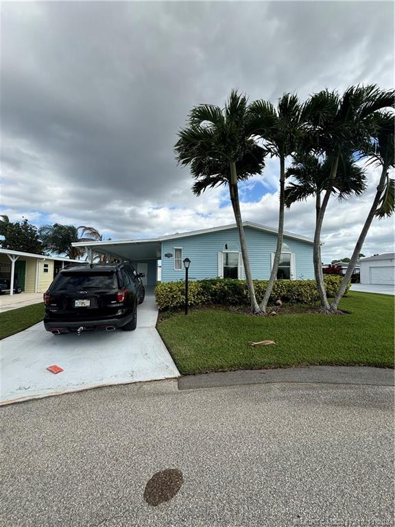 a view of a house with a yard and garage