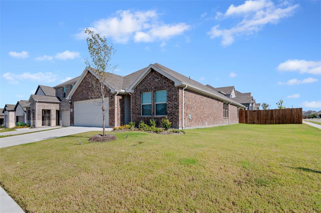 a front view of a house with a garden and yard