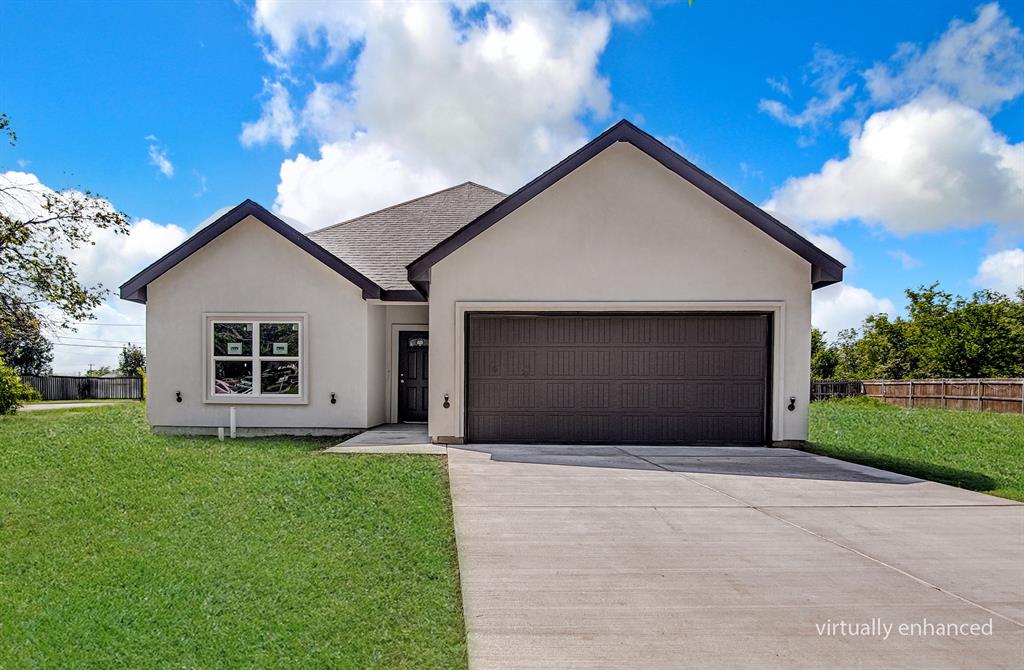 a front view of house with a yard and garage