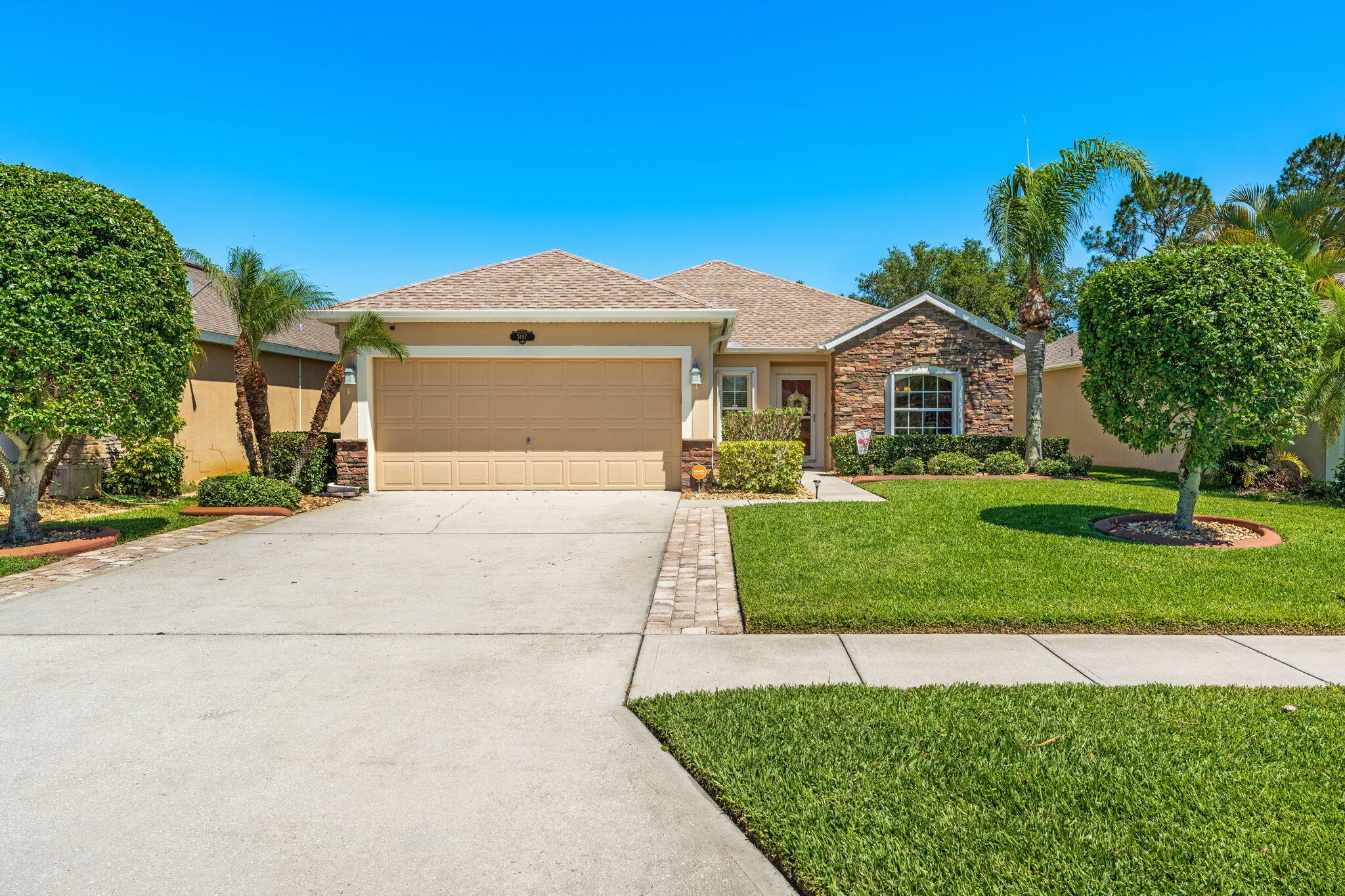 a front view of a house with a yard and garage