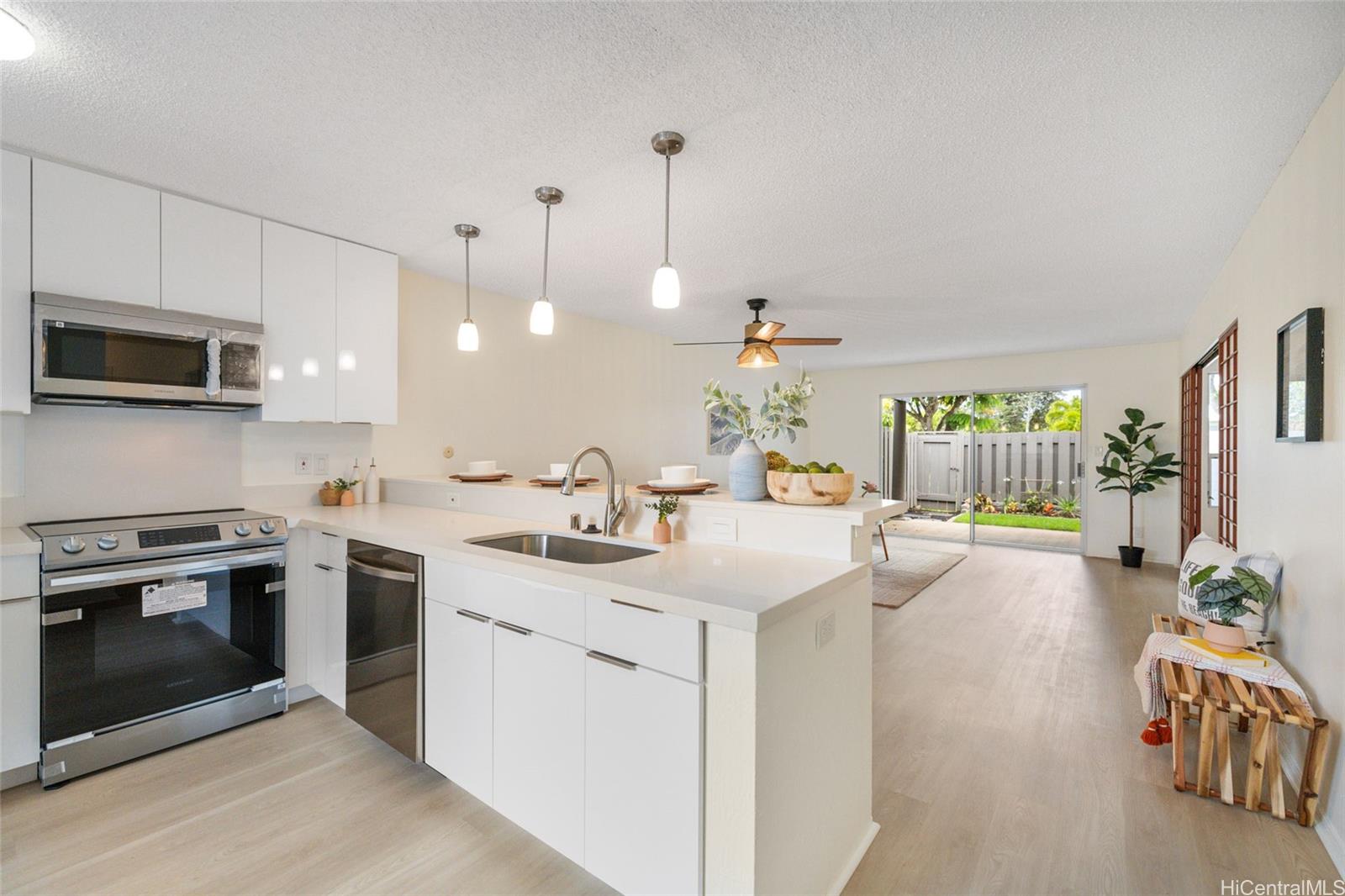 a kitchen with a sink and a stove top oven