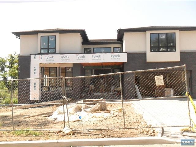 a view of a house with wooden fence