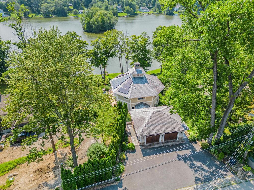 a aerial view of a house with garden space and a lake view