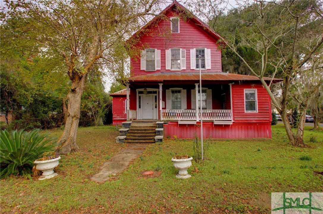 Façade of house with sidewalk, brick steps and lat