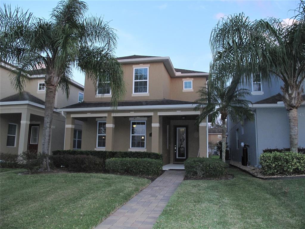 a front view of a house with a garden