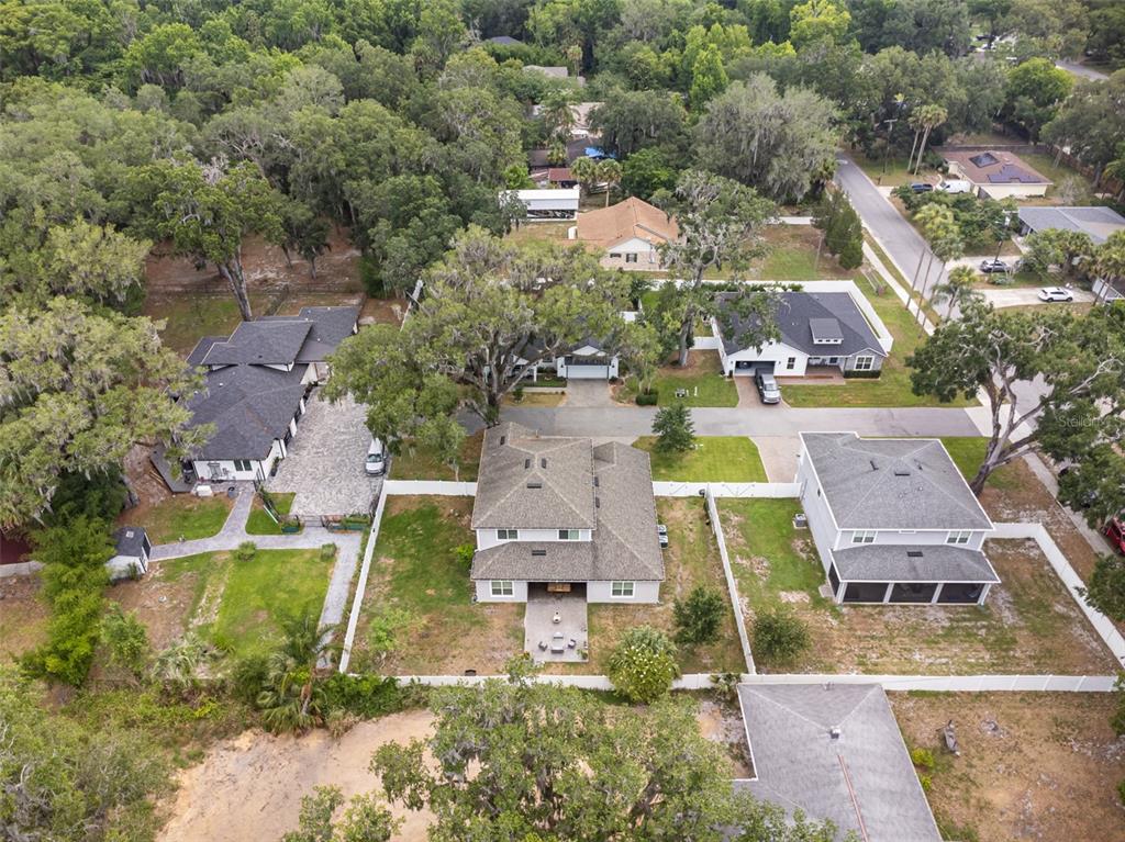 an aerial view of residential houses with outdoor space and parking