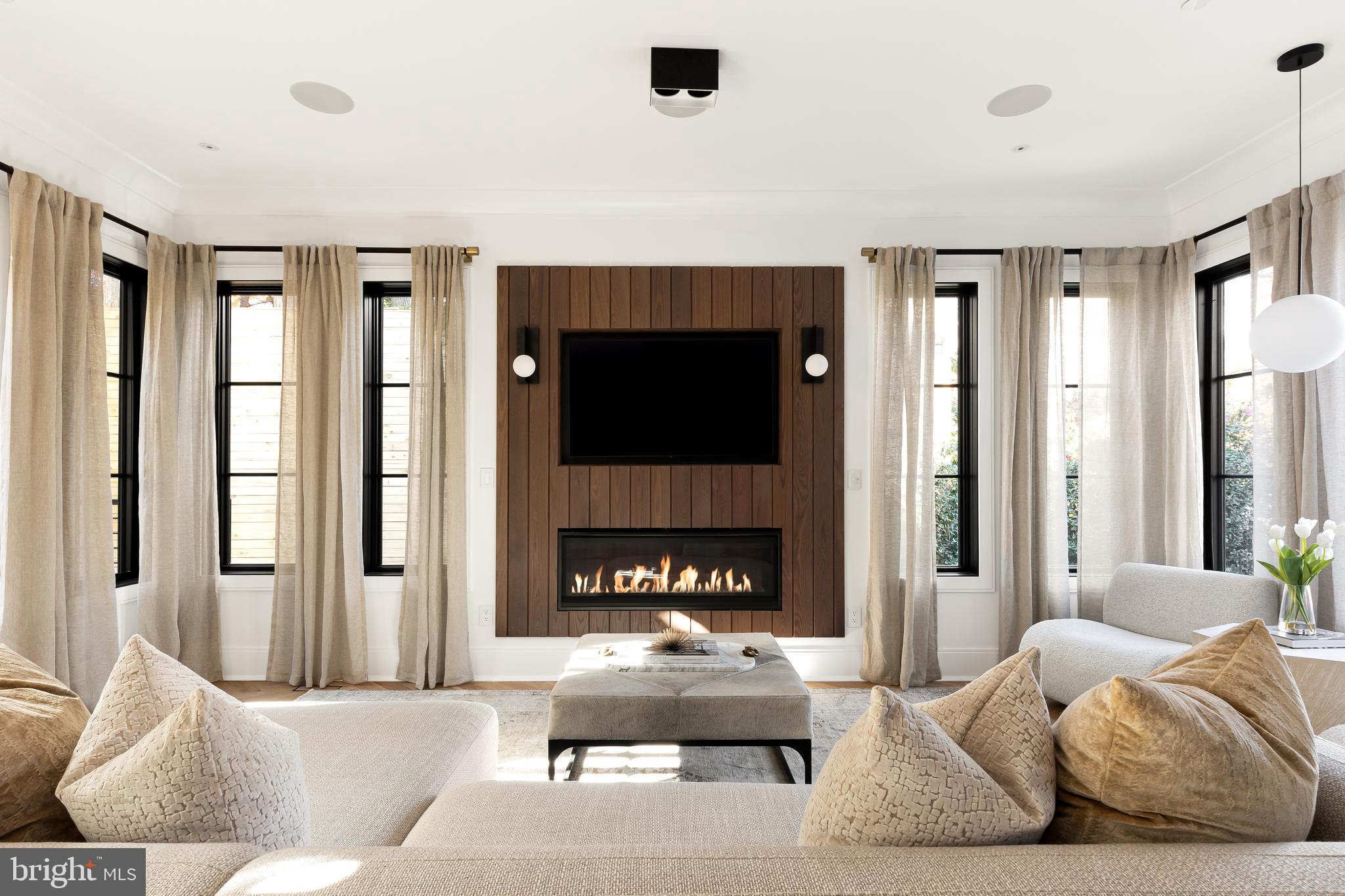 a living room with furniture fireplace and flat screen tv