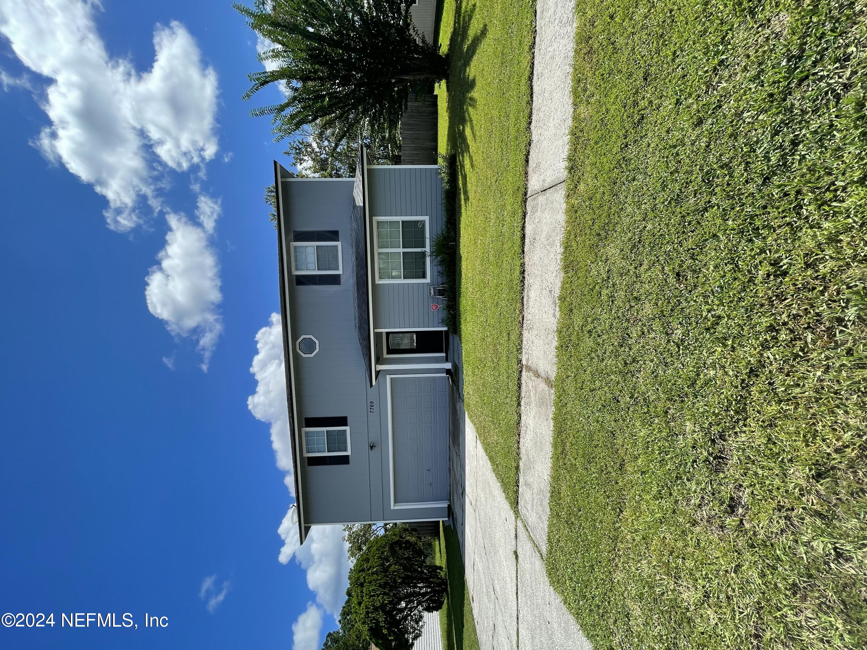 a view of a house with a yard