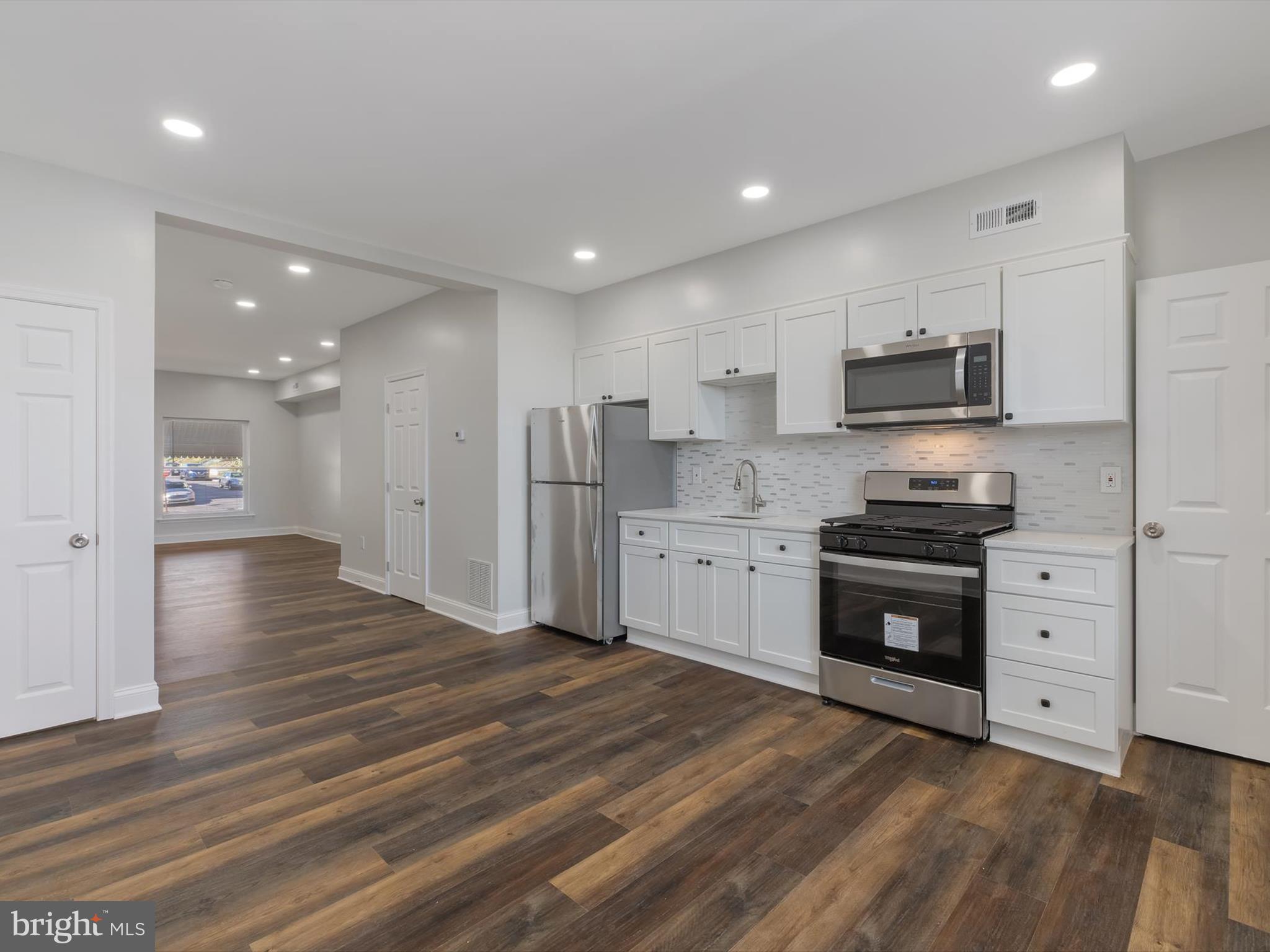 a kitchen with stainless steel appliances cabinets a sink and a stove