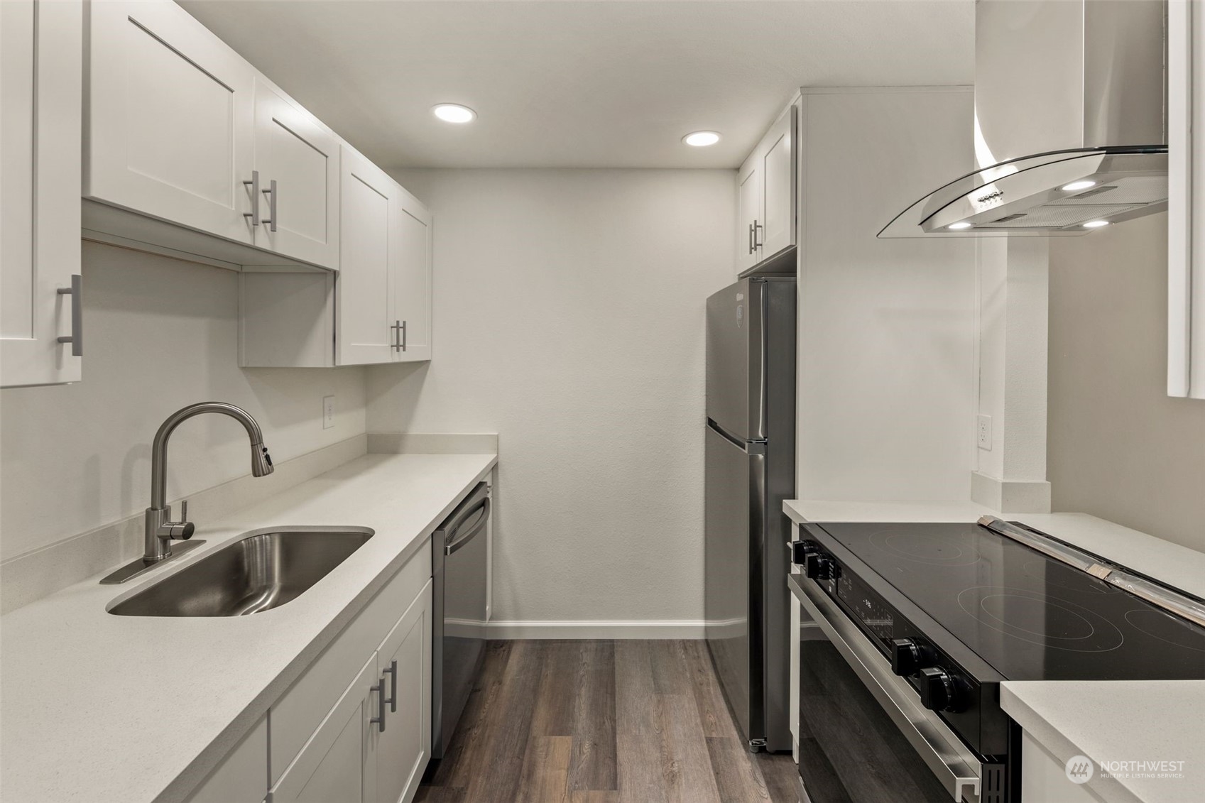 a kitchen that has a sink and a stove in it