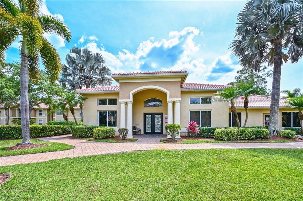 Mediterranean / spanish-style home with a front yard and french doors